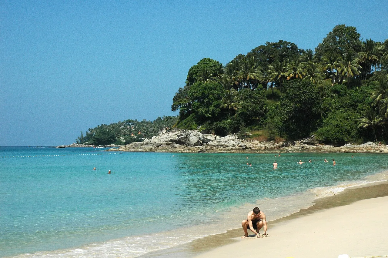 Clear turquoise water and tropical headland at Surin Beach